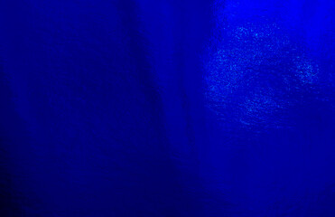 Blue foil background with uneven texture