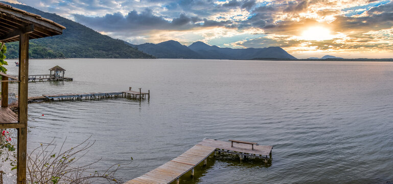 Panoramic view of Lagoa da Conceicao in Florianopolis, Brazil - Rustic houses and wooden piers on the water's edge.