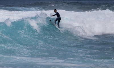 PUERTO DE SANTIAGO, TENERIFE - JUNE 2022: surfer riding the waves in Tenerife