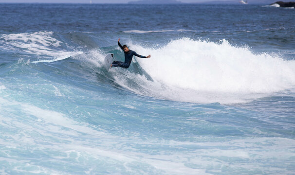 PUERTO DE SANTIAGO, TENERIFE - JUNE 2022: surfer riding the waves in Tenerife - Powered by Adobe