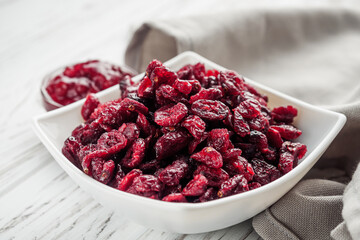 dried cranberry berry on a white wooden rustic background