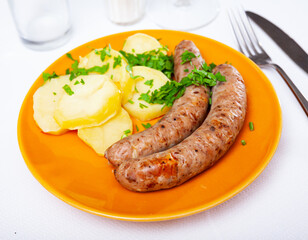 Appetizing sausages with potatoes and onion closeup - eastern european cuisine
