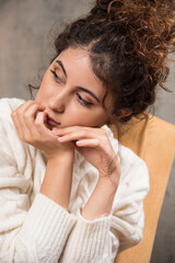 Photo of young woman sitting in comfy chair near Christmas tree