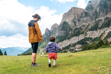A mother in nature with her son in the Tena valley in the Pyrenees, Huesca, Spain