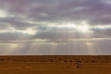 Natural sunbeams in a very cloudy  sky