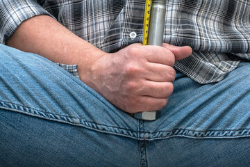 Measurement of penis size by a man. Photo for medicine and psychology