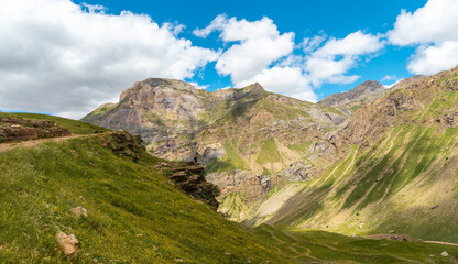 A young man looking at the landscape in the rincon del verde and the Salto de Tendenera Waterfall in the Ripera Valley, Pyrenees