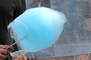 Candy floss. Hand holding cotton candy. 