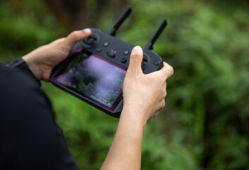 People taking photo with drone in summer forest