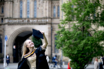 Portrait of a happy woman on her graduation day at university. Education and people.
