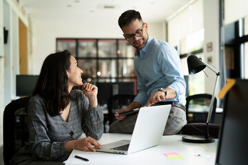 Colleagues in office. Businesswoman and businessman discussing work in office..