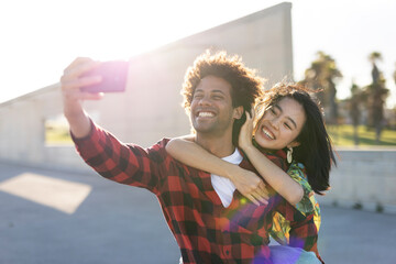 Beautiful young couple in love at the city street. Happy couple taking selfie photo