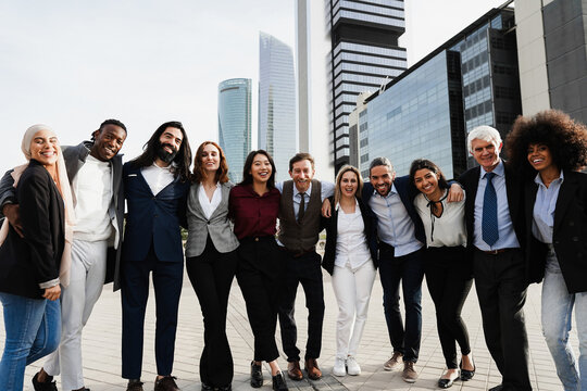 Multiethnic Business People Celebrating Outside Of The Office With City In Background - Focus On Center Faces