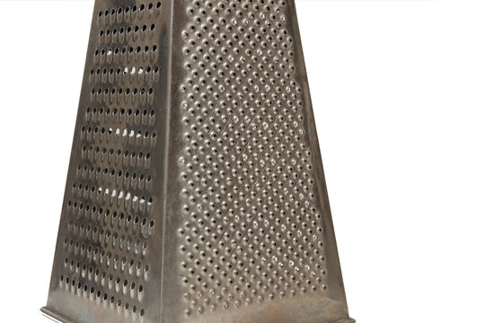 Closeup of a grater for vegetables and cheese on a white background. Kitchen concept.