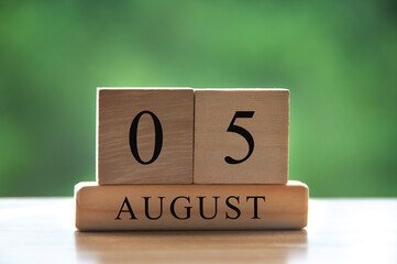 August 5 calendar date text on wooden blocks with blurred background park. Copy space and calendar concept