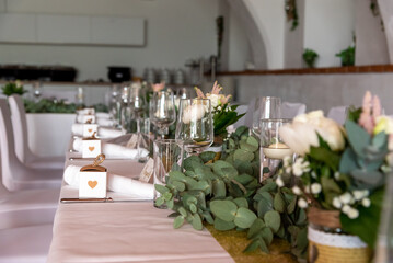 festive decorated table with glasses and flowers at a celebration