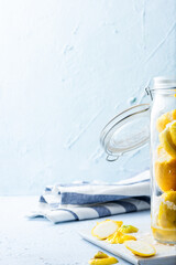 Lemons in jar, kitchen and food background