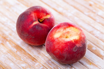 Naklejka na ściany i meble Delicious ripe peaches fruit on wooden surface close up