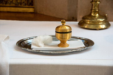 chrism oil in a golden pot for baptism