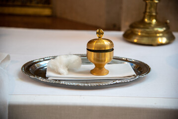 Fototapeta na wymiar chrism oil in a golden pot for baptism