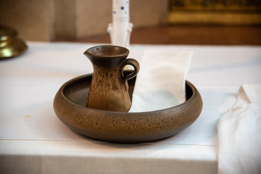 pot with sacred holy water and napkin for baptism