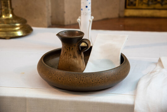 pot with sacred holy water and napkin for baptism
