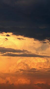 Dramatic clouds in the sunset sky, timelapse vertical video