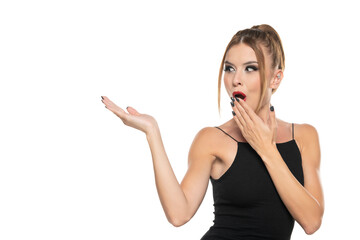 Excited happy woman with makeup and hairstyle, advetising product on her palm,  front view on a white background