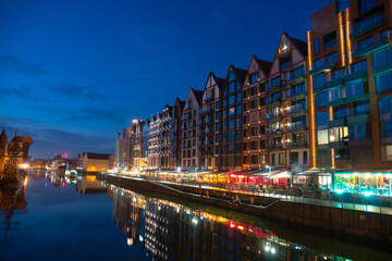 Scenic summer evening panorama of the architectural embankment pier canal river illumination of the Old Town GDANSK, POLAND