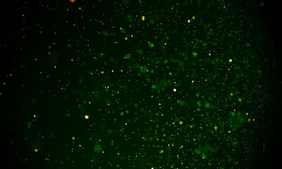 Bokeh effect of glittering water droplet spray enhanced by the use of ombre green-gold lighting effects background.