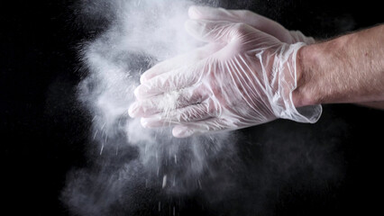 Chef Hands Clapping With Flour In Slow Motion on black background. Frame. Chef Claps Hands Together...
