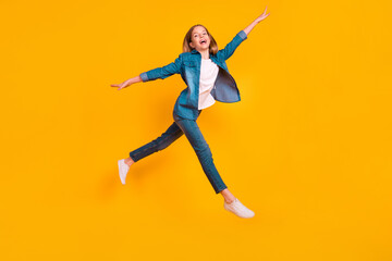 Full body portrait of excited crazy person jumping hands wings flight isolated on yellow color background
