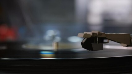 The Cartridge and stylus of Vinyl Record player playing on black vinyl record music 