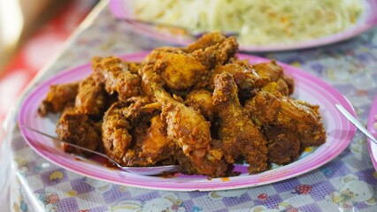 pile of meat cooked with spices, on a big plate on the table for buffet