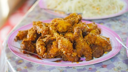 pile of meat cooked with spices, on a big plate on the table for buffet
