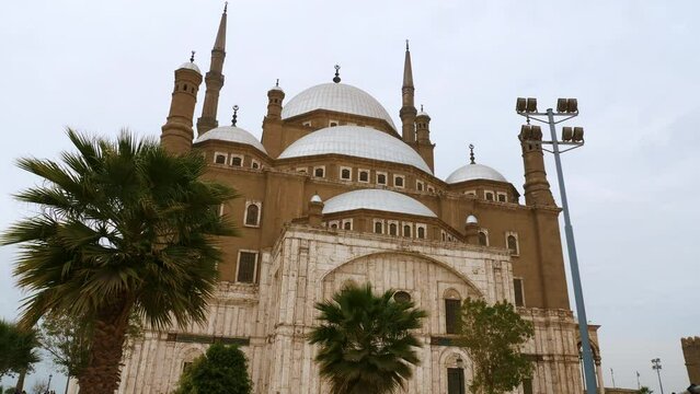 Great Mosque of Muhammad Ali Pasha or Alabaster surrounded trees. Religious landmarks, tourist attractions of Cairo. Islamic architecture of Egypt. Exterior, front view, facade of building