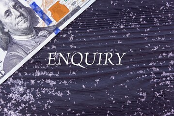 ENQUIRY - word (text) on a dark wooden background, money, dollars and snow. Business concept (copy space).