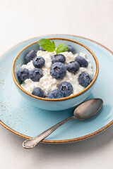 Cottage cheese with blueberry, fresh berries, keto healthy breakfast concept, top view.