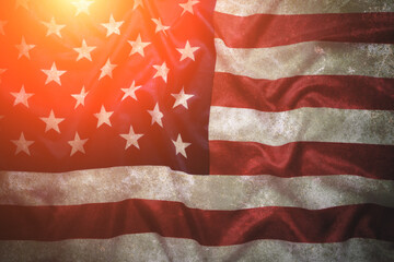 Aged background, flag United States America with bright sunlight.
