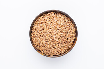 Wheat grains and wooden bowl on white background.
