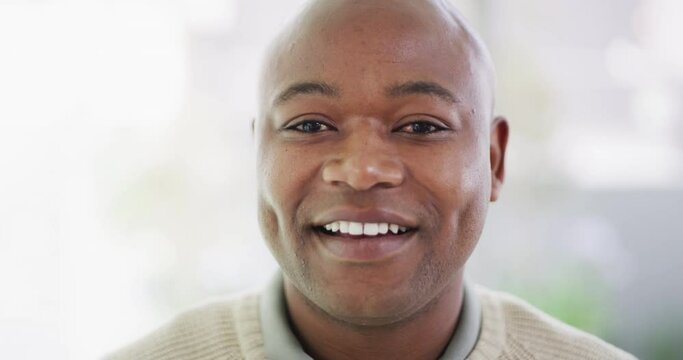 Portrait of the face of one mature African American man with a bright smile and white teeth. A smiling, happy bald black guy showing porcelain veneers after a dental treatment at the dentist