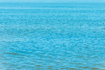 Beautiful turquoise blue sea calm wave summer shot.Banner,copy space.Toned.