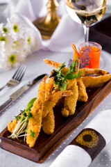Tempura prawns with sweet and sour sauce and a glass of white wine