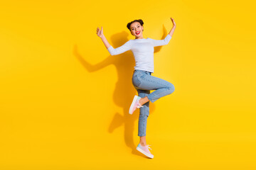 Fototapeta na wymiar Full length photo of sweet excited lady wear long sleeve jumping high empty space isolated yellow color background