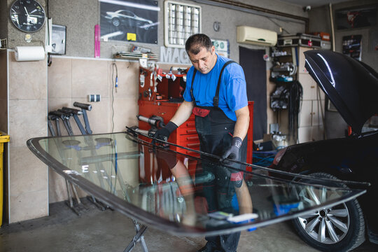 Replacement of car glass in a car service.