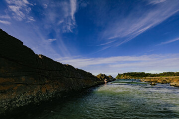 Children swimming at The Tanks tourist attraction natural rock pool at Forster, NSW Australia
