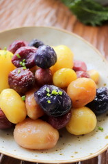 colored peeled boiled potatoes close-up in clay plate selective focus
