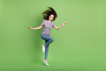 Fototapeta na wymiar Full body photo of overjoyed cheerful person have fun jumping toothy smile isolated on green color background