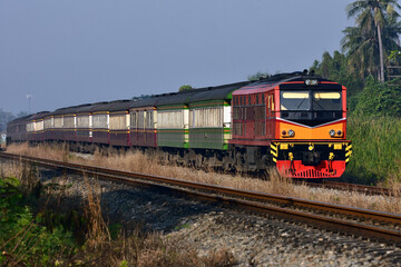 Fototapeta na wymiar Thai passenger train by diesel locomotive on the railway