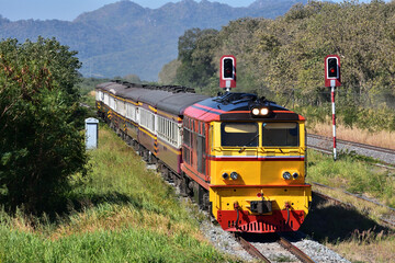 Thai passenger train by diesel locomotive on the railway